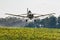 Low Flying Aircraft Spraying a Field of Sunflowers