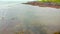Low-flying drone video during low tide of the St-Lawrence River showing the rocks on the beach at St-Ulric, Qc