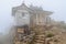 Low fog and mist surrounds small shrine on top of Mt. Ishizuchi in Shikoku, Japan