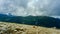 low hanging storm clouds and fog in the mountains on a summer day. blue haze in mountain valleys.