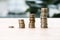 Low and high stacks of coins on table