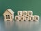 Low house rates symbol. Concept words \\\'Low rates\\\' on wooden cubes near miniature houses.