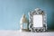 Low key image of vintage antique classical frame and Lantern on wooden table. filtered image