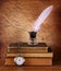 Low key image of white Feather, inkwell and ancient books on old wooden table.