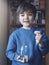 Low key light portrait of young Kid holding money coins in clear jar,  Child counting his saved coins, Childhood hand holding coin