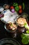 Low key moody shot showing roti paratha tortilla flatbread on glass plate surrounded by fresh vegetables like capsicum