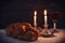 Low key shabbat image. challah bread, shabbat wine and candles
