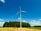 Low level aspect aerial view of a wind turbine in a small rural wind farm