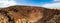 Low level panoramic view of the deep volcanic crater of Calderon Hondo volcano near Corralejo in Fuerteventura