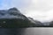 Low lying clouds across the mountains at Lake Manapouri in New Zealand