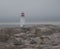 Low lying clouds along the ocean of Peggy`s Cove lighthouse