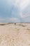 Low ocean tide and one human silhouette stands on the shore