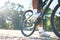 A low perspective of mountain cyclists on a rocky path at sunset Focus on shoes