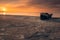 Low perspective with a rope leading to a fishing boat on the beach at sunrise