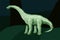 Low poly art with green diplodocus silhouette