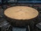 Low-quality wooden round tables present in the black and silver hall of the Estoril casino.