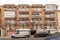 low rise urban residential house facades with open terraces on a winter day seen at street level