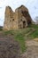 Low ruins of square castle building with entry door