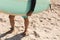 Low section of biracial senior man carrying surfboard standing barefoot on sand at sunny beach