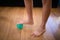 Low section of boy standing while stepping on stress ball