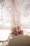 Low section of bride wearing silver sandals standing on rug