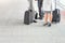 Low section of businesspeople with luggage standing on railroad platform