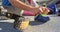 Low section of caucasian disabled male athlete sitting, tying shoe