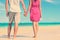 Low Section Of Couple Holding Hands On Beach