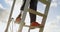 Low section of disabled woman climbing ladder in the park 4k