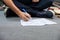 Low Section Of Drummer Writing Notes While Sitting On Floor