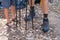 Low section of father and son with hiking poles in forest