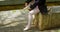 Low section of female ballerina wearing ballet shoe in the park 4k