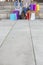 Low section of female friends with shopping bags sitting on steps with sidewalk on foreground