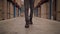 Low section of a manager walking towards camera in the large warehouse distribution center