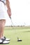 Low section of mid-adult man playing golf against clear sky