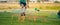 Low section portrait of unrecognizable boy jumping over hurdles in football field