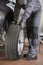 Low section of repairman fixing car\'s tire in workshop