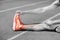 Low section of sportswoman stretching on sports track