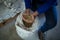 Low section of worker examining barley