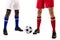 Low section of young male multiracial soccer players standing by ball over white background