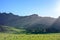 Low sun casting long shadows accross green valley. Majestic ridge of Te Mata rising under clear blue sky