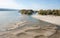 Low tide of the Danube river with people silhouettes walking on the sand islands left after water withdrawal in the Novi Sad, Serb