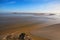 Low tide in front of Mont Saint-Michel abbey. Amazing landmark. Sunny spring morning view. Normandy, France, Europe