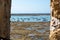 Low tide time on ocean coast of Cadiz, shallow water with fishing boats and seagulls, Andalusia, Spain