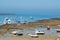 Low tide time on ocean coast of Cadiz, shallow water with fishing boats and seagulls, Andalusia, Spain