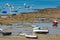 Low tide time on ocean coast of Cadiz, shallow water with fishing boats and seagulls, Andalusia, Spain