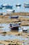 Low tide time on ocean coast of Cadiz, shallow water with fishing boats and seagulls, Andalusia, Spain