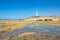 Low tide in Trafalgar Cape with rocky seaside and lighthouse reflected