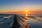 Low tide uncovered a coastal protection while the sun sets over the wadden sea