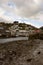Low tide view West Looe houses on hill from slipway.. Cloudy Spring day.